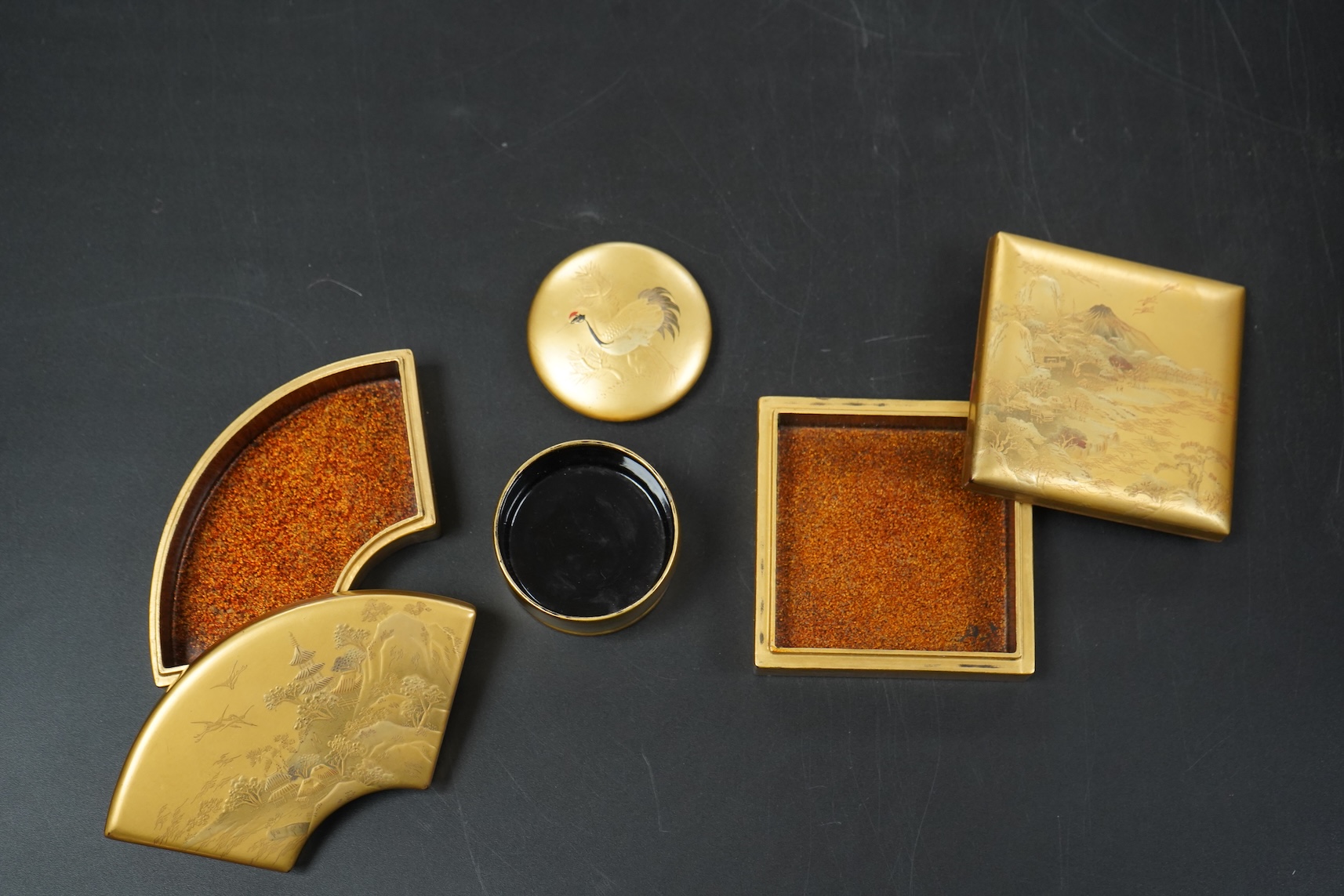 Three Japanese gilt lacquer boxes, one depicting Mount Fuji, largest 9cm wide